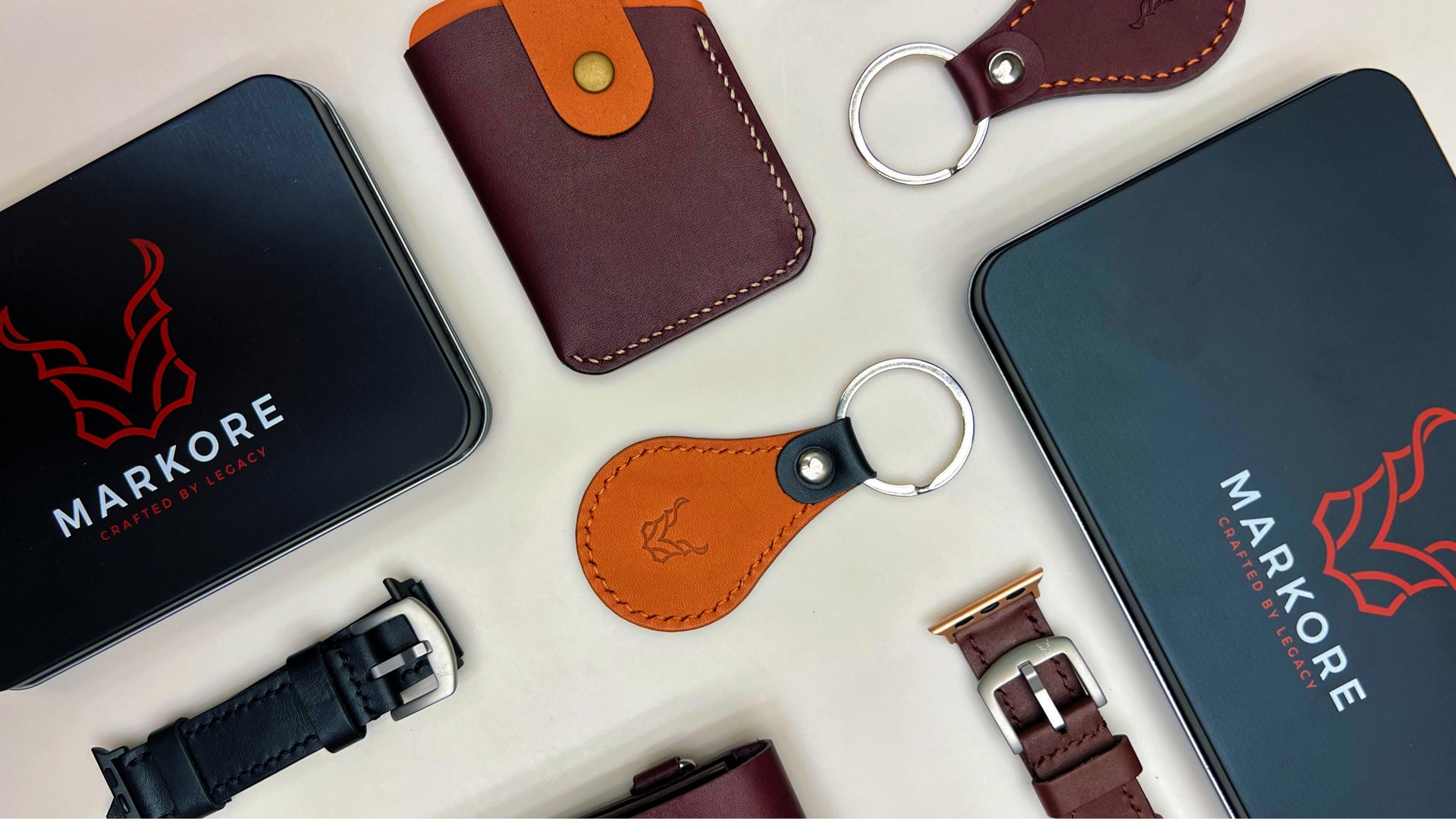 Collection of markore berlin leather products including wallets, keychains, and watch straps with Markore branding.
