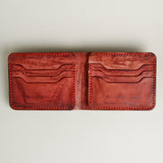 Inside view of hand-painted full-grain leather bifold wallet in red, featuring card slots and handmade stitching. Markore Canvas Flame.