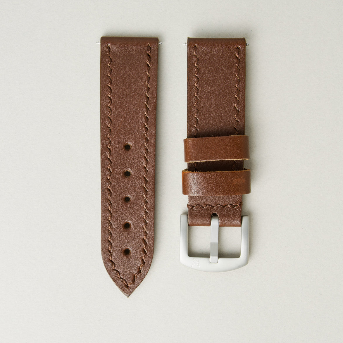 Espresso brown full-grain leather watch strap with handmade stitching, matching leather loops, and stainless steel buckle. Markore Hour Line.