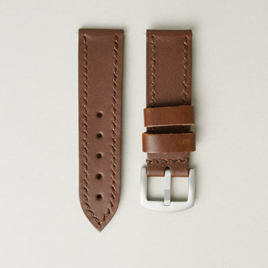 Espresso brown full-grain leather watch strap with handmade stitching, matching leather loops, and stainless steel buckle. Markore Hour Line.