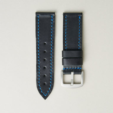 Midnight full-grain leather watch strap with blue stitching, matching leather loops, and stainless steel buckle. Markore Hour Line.