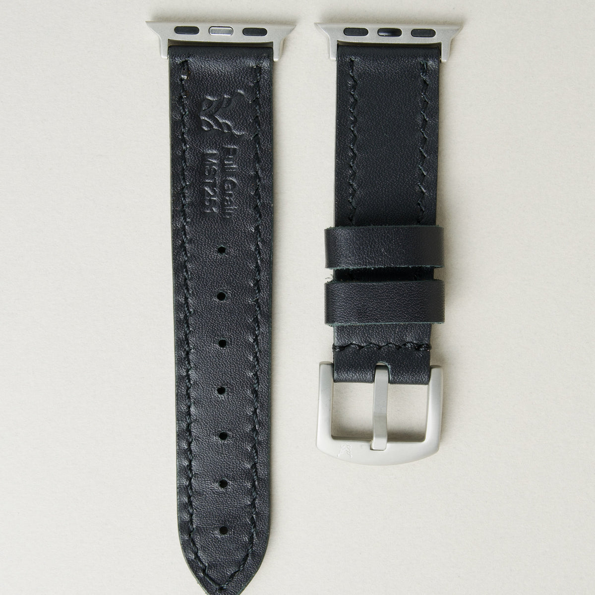 midnight black full-grain leather watch strap with silver stainless steel adapters and buckle, featuring handmade stitching and matching loops. Markore Hour Line.