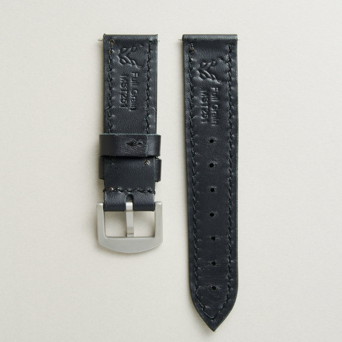 Back view of Midnight Black leather strap with stainless steel buckle, showing handmade stitching, embossed logo, and serial number. Markore Hour Line.