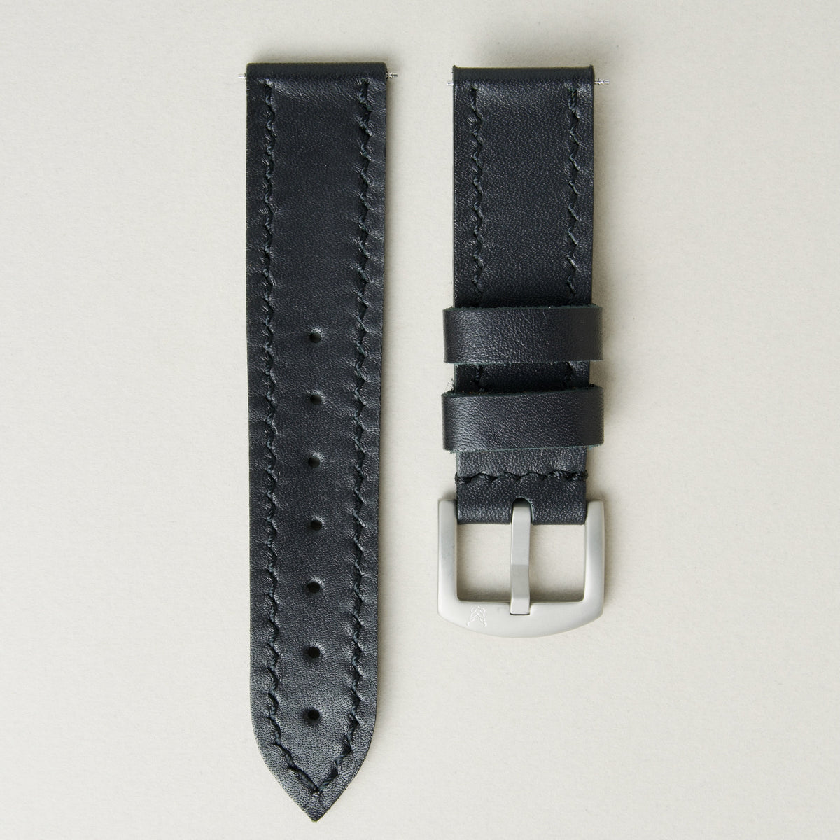 Midnight full-grain leather watch strap with handmade stitching, matching leather loops, and stainless steel buckle. Markore Hour Line.