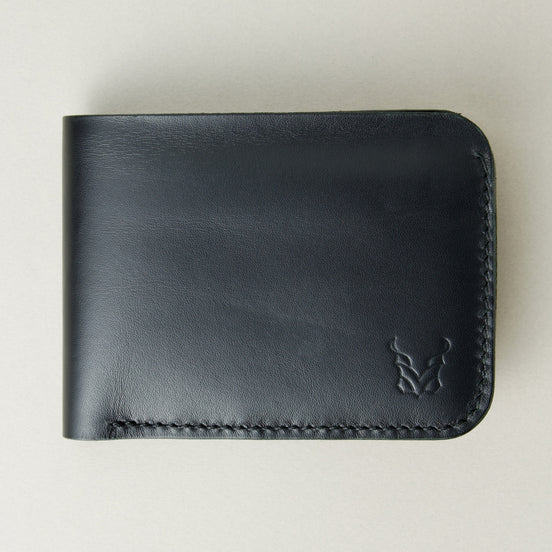 Front view of full grain leather bifold wallet in midnight black featuring handmade stitching and embossed logo. Markore Hunza Fold.