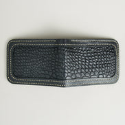 Outside view of obsidian black croc-embossed full-grain leather bifold wallet featuring ivory handmade stitching. Markore Indus Sultan