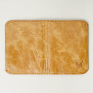 Back view of leather bifold wallet in natural, featuring handmade stitching and embossed logo. Markore Natural.