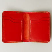 Inside view of red full-grain leather wallet featuring card slots and ivory handmade stitching. Markore Ravi Fold.