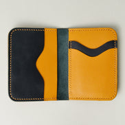 Inside view of midnight black full-grain leather wallet featuring midnight black and amber card slots and amber handmade stitching. Markore Ravi Slip.