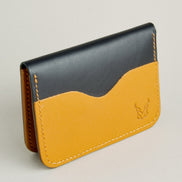 Side view of midnight black full-grain leather wallet featuring amber card slot, amber handmade stitching and embossed logo. Markore Ravi Slip.