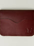 Front view of espresso brown full-grain leather wallet featuring card slot, handmade stitching and embossed logo. Markore Ravi Slip.