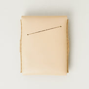 Back view of natural full-grain leather flap wallet featuring a card slot. Markore Sutlej Vault.