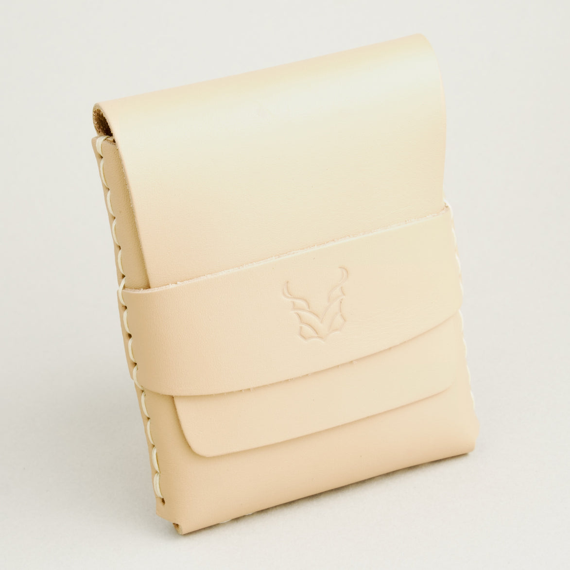 Side view of natural full-grain leather flap wallet featuring a flap holder with embossed logo, and handmade stitching. Markore Sutlej Vault.