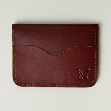 Front view of espresso brown full-grain leather wallet featuring card slot, handmade stitching and embossed logo. Markore Ravi Slip.