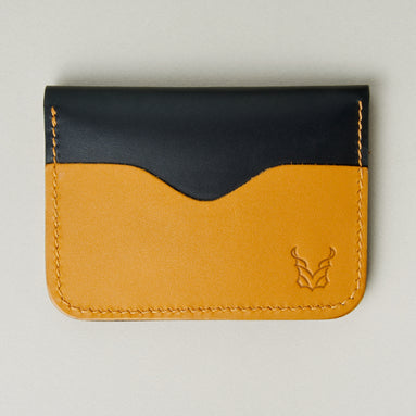 Front view of midnight black full-grain leather wallet featuring amber card slot, amber handmade stitching and embossed logo. Markore Ravi Slip.