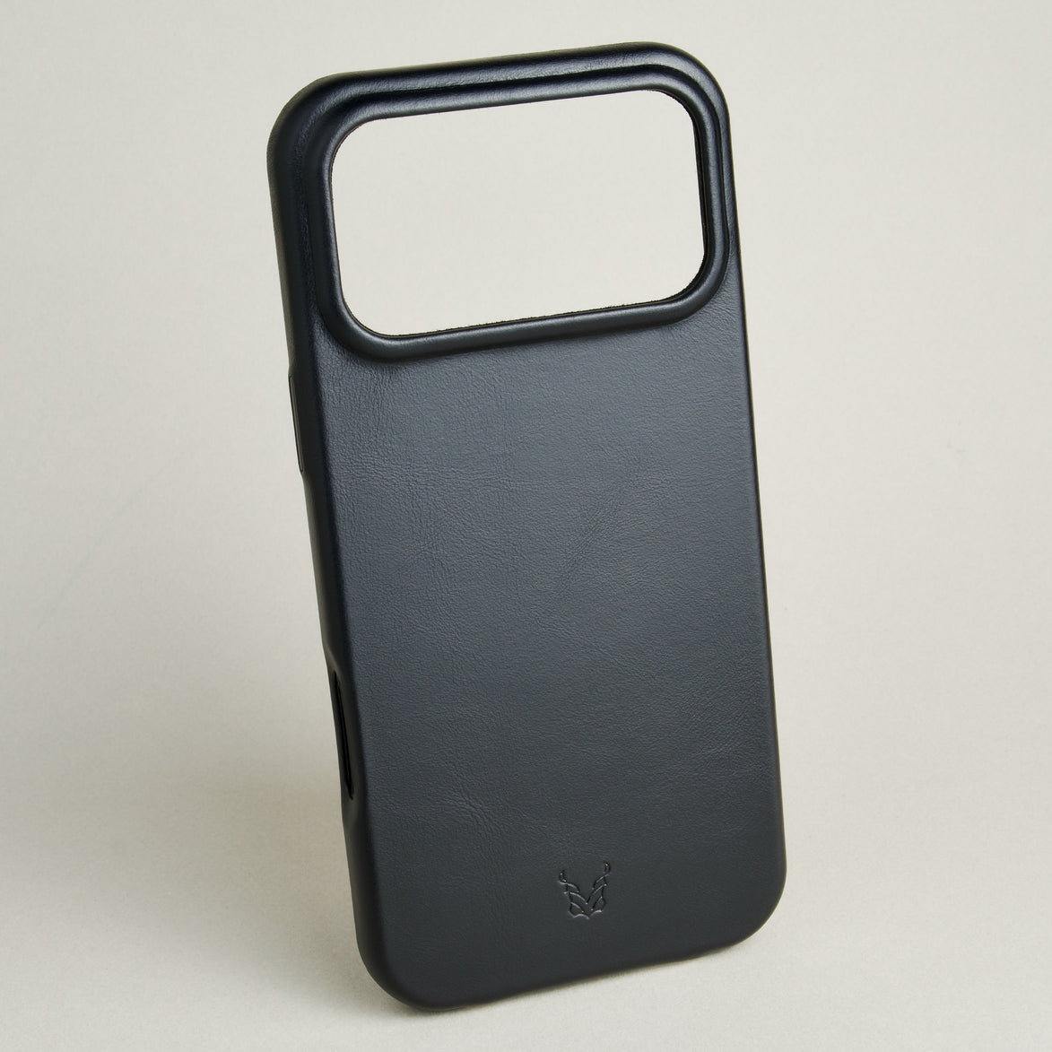 Outside side view of midnight black leather iPhone 17 cover showing embossed brand logo. Markore Shell Guard.