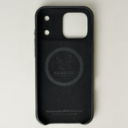 Inside view of midnight black leather iPhone 17 cover showing velvet lining with brand logo and inscription. Markore Shell Guard.